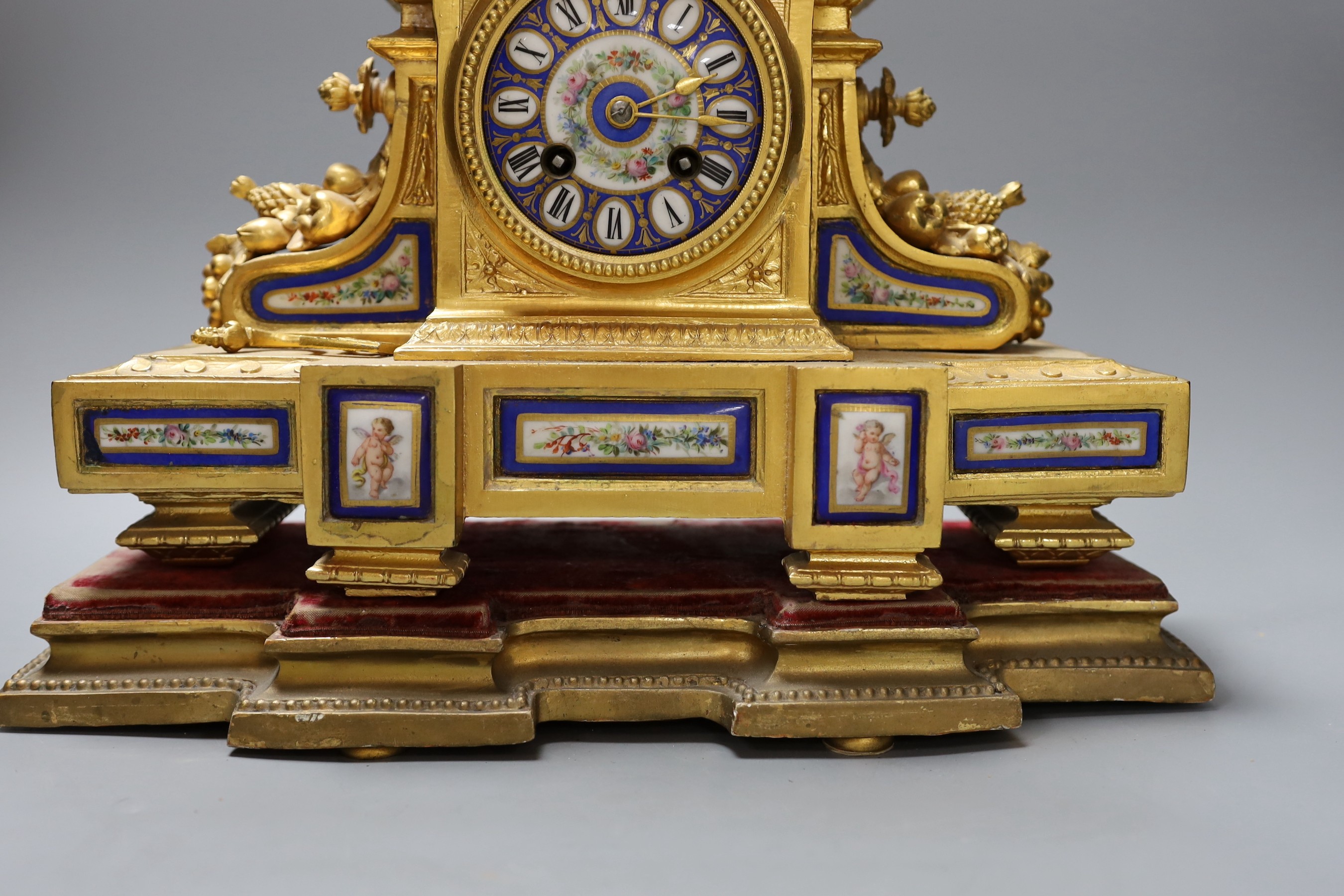 A 19th century French gilt metal and Sevres style enamel mantel clock, 37cm wide